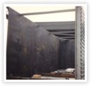 Half section of an oil storage tank c/w insulation and cladding